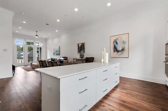 1312 Tinnin Ford Road Austin, TX 78741 - Photo 8 of 12 a large kitchen with stainless steel appliances a large counter top a wooden floor and a large window