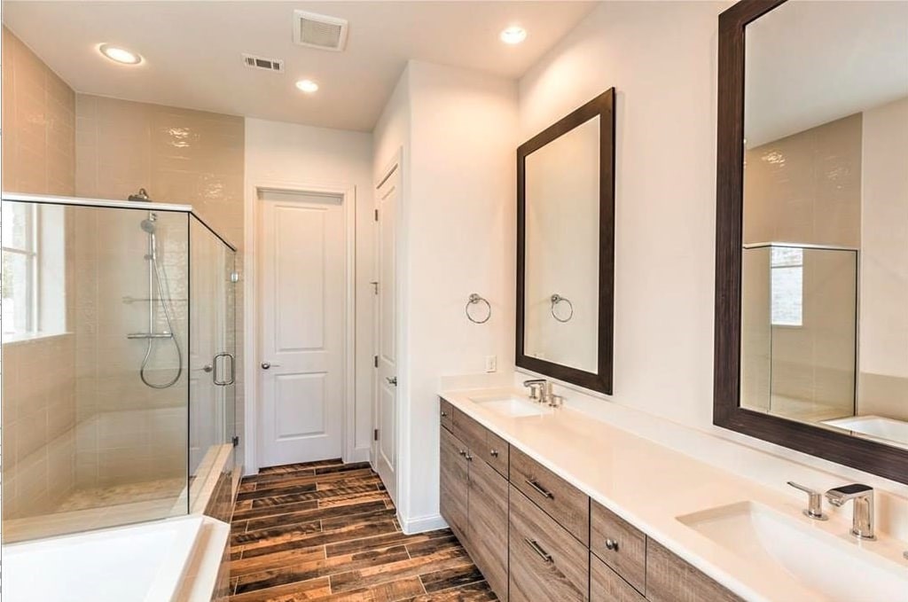 1312 Tinnin Ford Road Austin, TX 78741 - Photo 10 of 12 a spacious bathroom with a double vanity sink mirror and shower