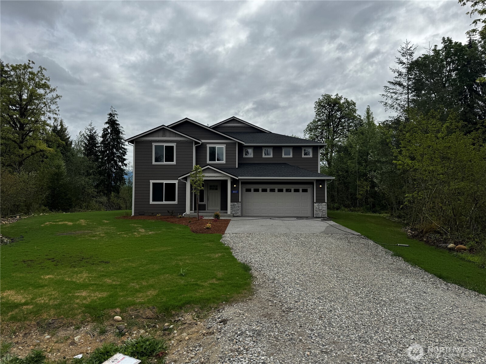 8657 Trillium Lane Concrete, WA 98237 - Photo 1 of 28 a front view of a house with a garden