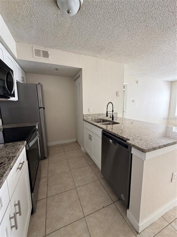 2201 Key W Court, Unit 314 Kissimmee, FL 34741 - Photo 16 of 58 a kitchen with a sink and cabinets