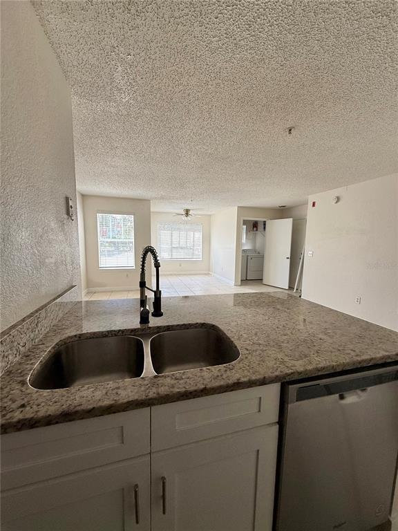 2201 Key W Court, Unit 314 Kissimmee, FL 34741 - Photo 17 of 58 a kitchen with granite countertop a sink and cabinets