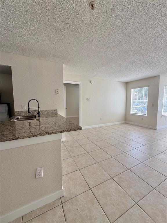 2201 Key W Court, Unit 314 Kissimmee, FL 34741 - Photo 18 of 58 a bathroom with a granite countertop sink and a mirror
