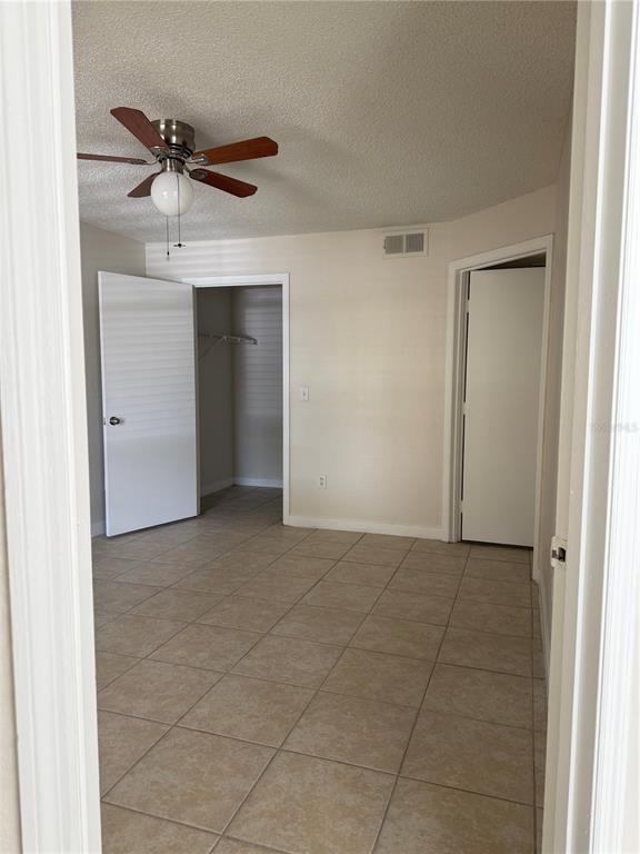2201 Key W Court, Unit 314 Kissimmee, FL 34741 - Photo 24 of 58 a view of an empty room with a ceiling fan