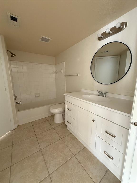 2201 Key W Court, Unit 314 Kissimmee, FL 34741 - Photo 31 of 58 a bathroom with a sink a toilet and a mirror