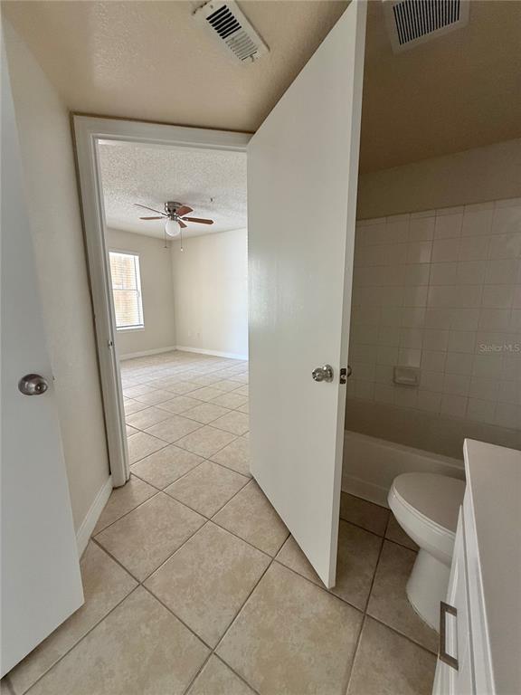 2201 Key W Court, Unit 314 Kissimmee, FL 34741 - Photo 32 of 58 a bathroom with a granite countertop shower and a toilet
