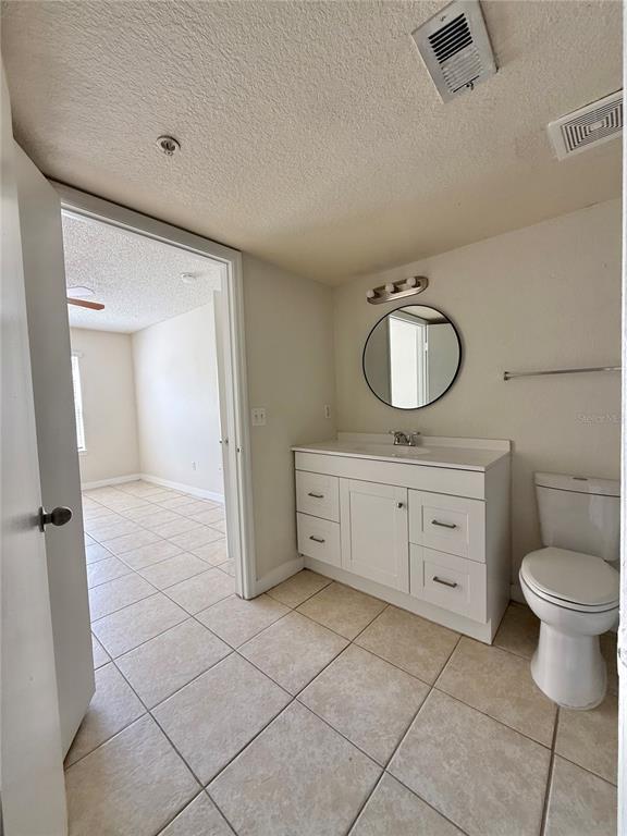2201 Key W Court, Unit 314 Kissimmee, FL 34741 - Photo 46 of 58 a bathroom with a toilet a sink a mirror and vanity
