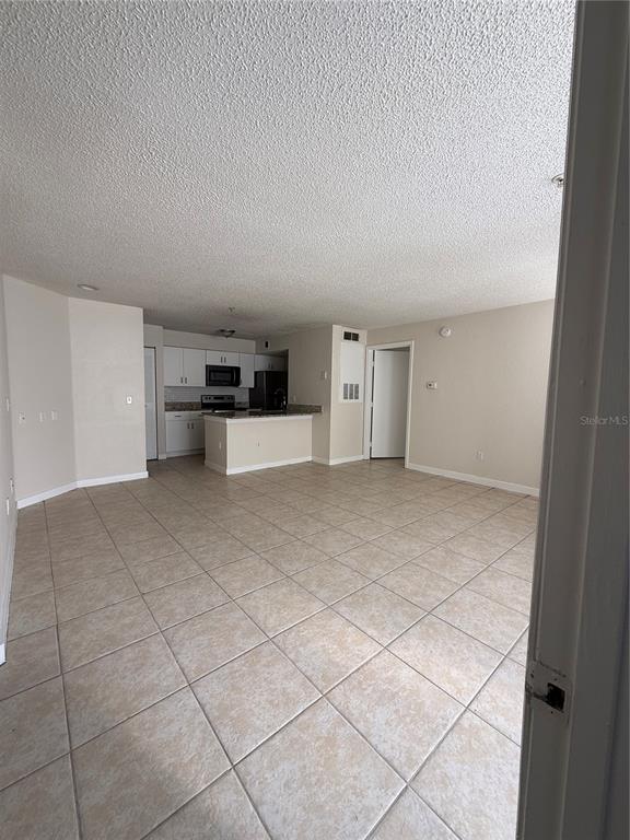 2201 Key W Court, Unit 314 Kissimmee, FL 34741 - Photo 9 of 58 a view of empty room with kitchen and window