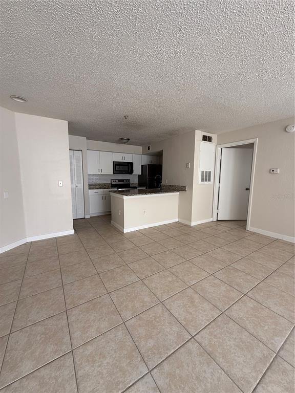 2201 Key W Court, Unit 314 Kissimmee, FL 34741 - Photo 10 of 58 a view of a kitchen with a sink and an empty room