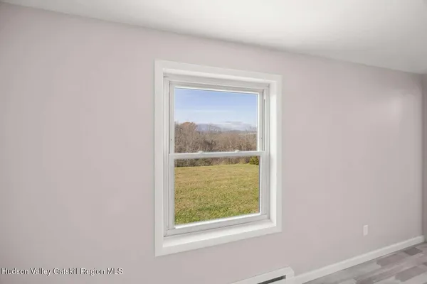 a view of an empty room and glass door
