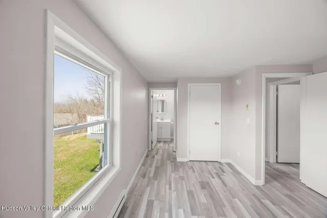 a bathroom with a toilet a sink a mirror and vanity