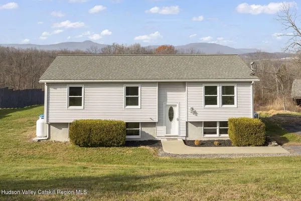 a view of a house with backyard and sitting area