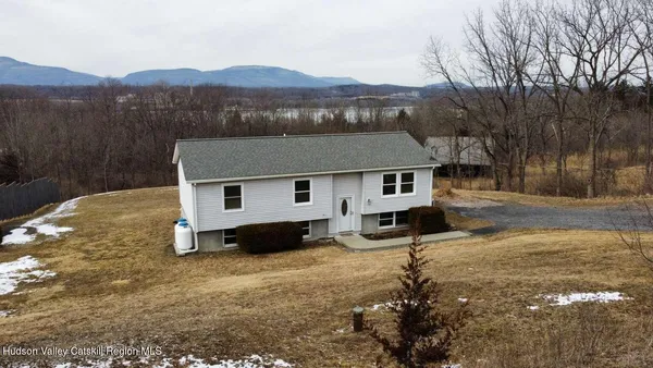 a aerial view of a house next to a yard