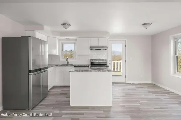 a kitchen with a sink a stove and refrigerator