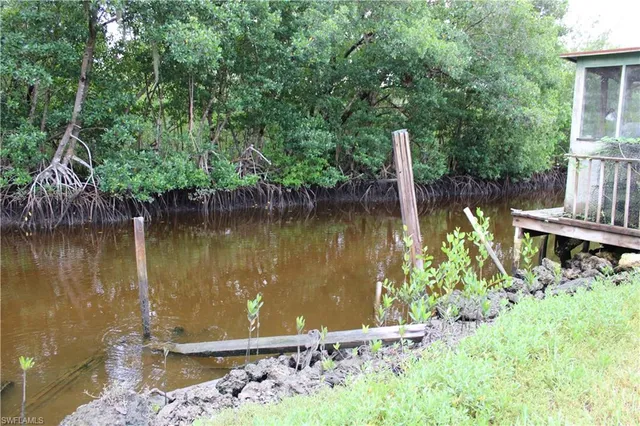 a view of a lake with a house in the background