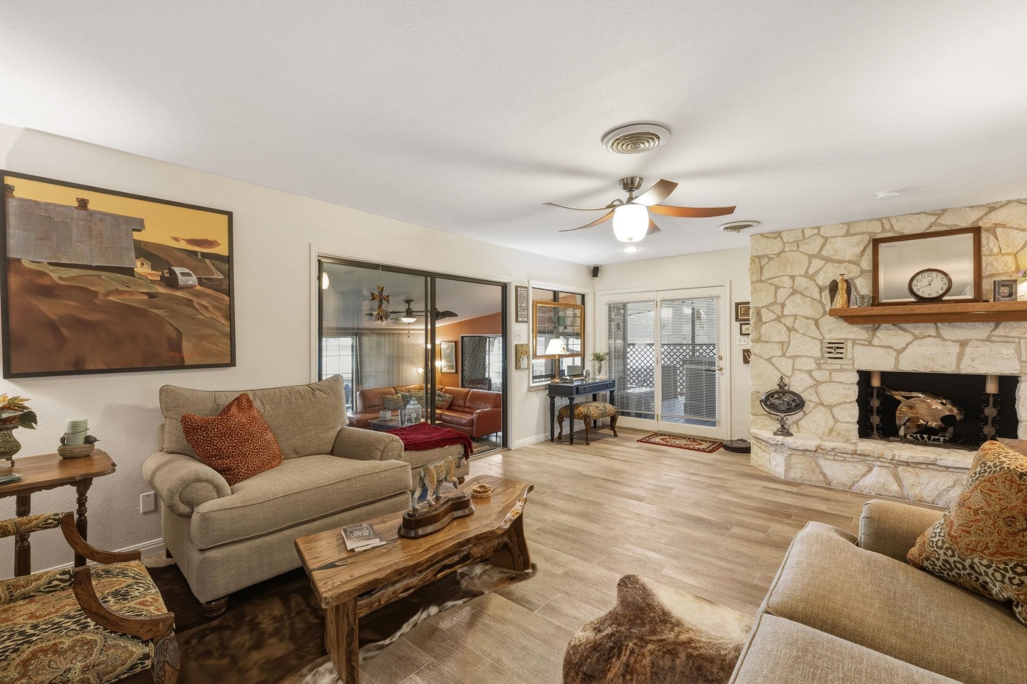 1435 East Zipp Road New Braunfels, TX 78130 - Photo 20 of 43 a living room with furniture a fireplace and a chandelier