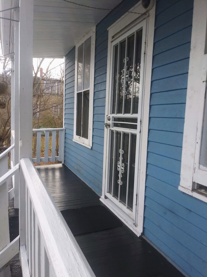 5921 South Aberdeen Street Chicago, IL 60621 - Photo 2 of 7 a view of a balcony with furniture and wooden floor