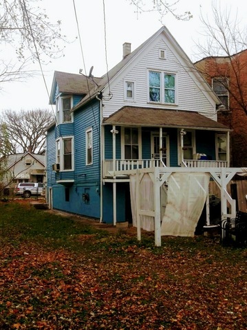 5921 South Aberdeen Street Chicago, IL 60621 - Photo 3 of 7 a view of a white house with a yard patio and deck