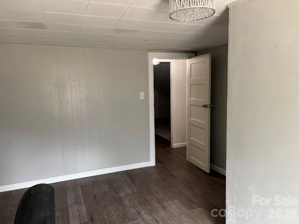 a view of hallway with wooden floor