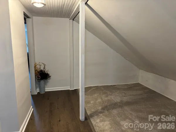 a view of a hallway with wooden floor and entryway