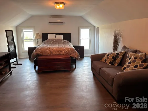 a spacious bedroom with a bed and window