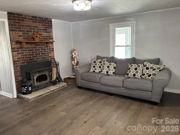 a living room with furniture a fireplace with wooden floor