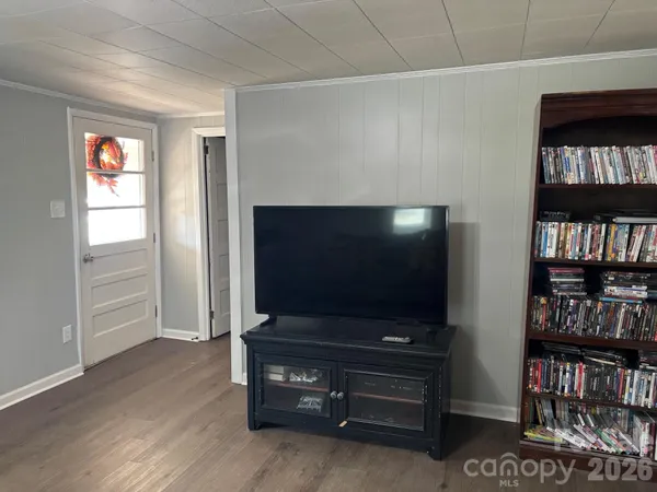 a living room with television cabinet and a flat screen tv