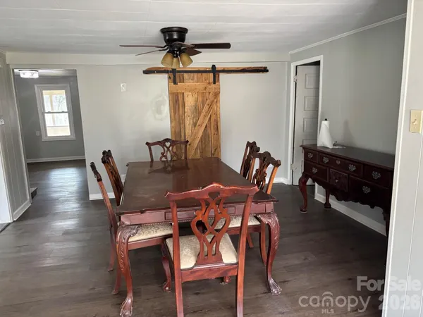 a dining room with furniture and window