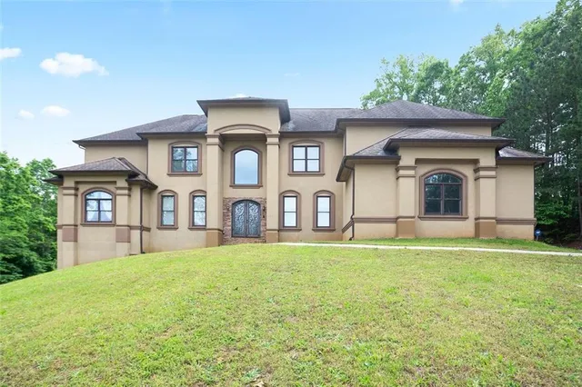a big house with a big yard and large trees
