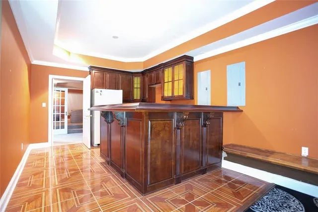 a spacious bedroom with a bed and wooden floor