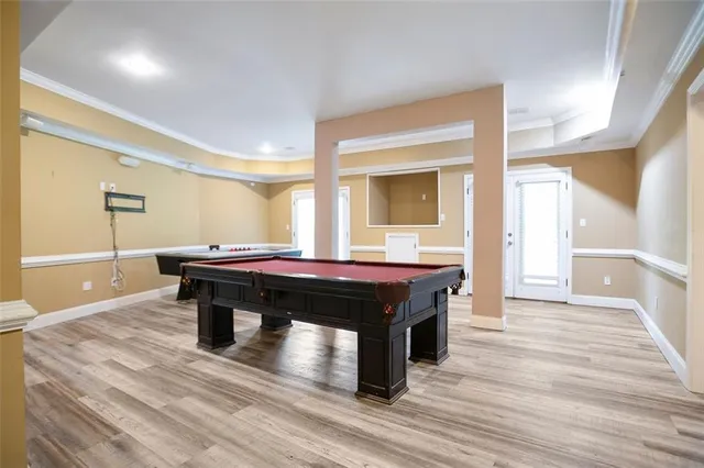 a room with a table chairs and wooden floor