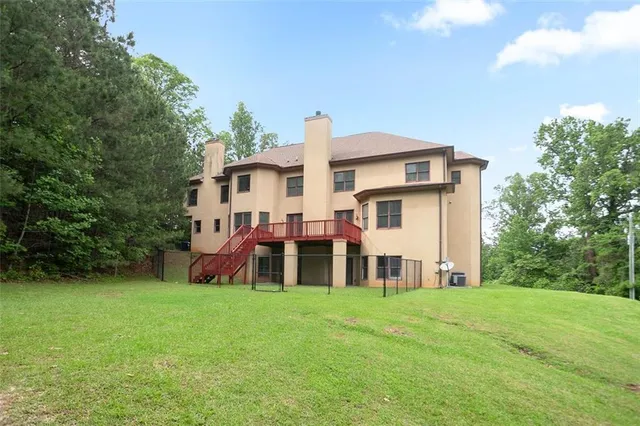 a view of a house with a yard and sitting area
