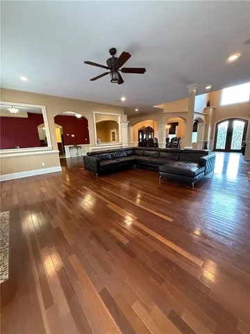 a living room with fireplace furniture and a wooden floor