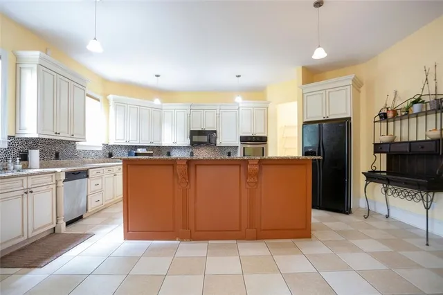a kitchen with stainless steel appliances granite countertop a refrigerator and a sink
