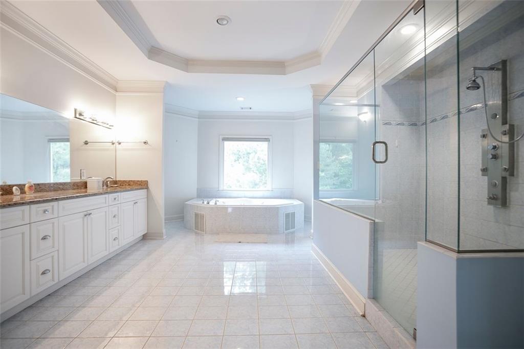 4370 Danforth Road Southwest Atlanta, GA 30331 - Photo 10 of 15 a large en suite bathroom with a tub sink and mirror