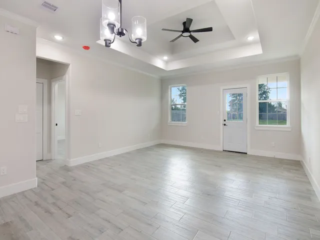 a open kitchen with white cabinets and stainless steel appliances