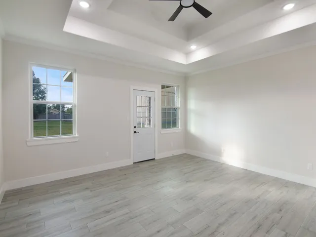 wooden floor in an empty room with a window