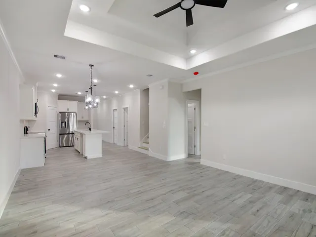 a view of an empty room with a kitchen