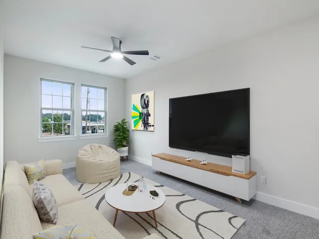 an empty room with a window and a fan