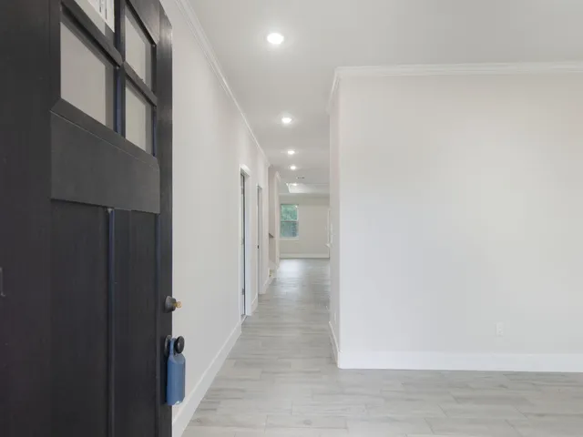 an empty room with wooden floor and a window