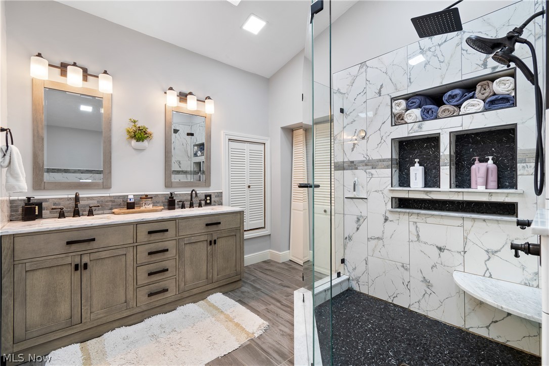 443 Merriman Road Akron, OH 44303 - Photo 21 of 44 Dual vanity featuring light wood-finish cabinetry, dark hardware, and rectangular mirrors