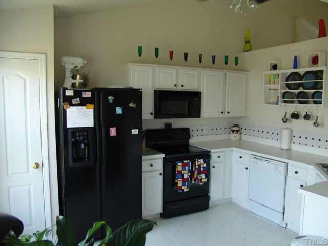 4808 Shallowbrook Trail Raleigh, NC 27616 - Photo 4 of 10 a kitchen with stainless steel appliances a refrigerator and cabinets