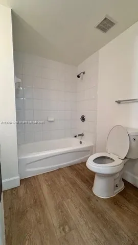 a bathroom with a toilet and a bathtub