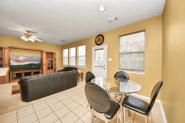 a bedroom with a bed and ceiling fan