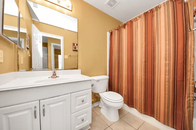 an aerial view of a house with a garden and swimming pool