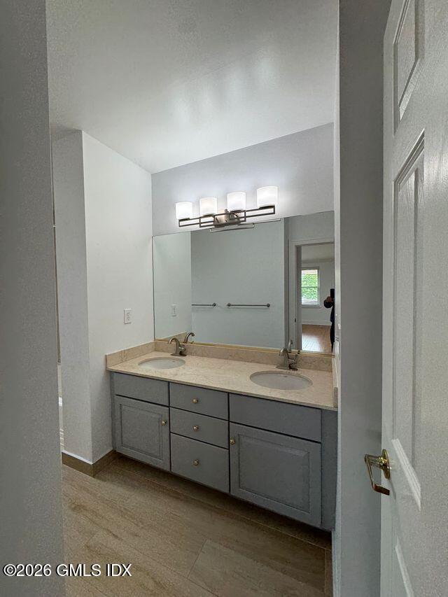 25 West Elm Street, Unit 40 Greenwich, CT 06830 - Photo 19 of 28 a bathroom with a double vanity sink and mirror