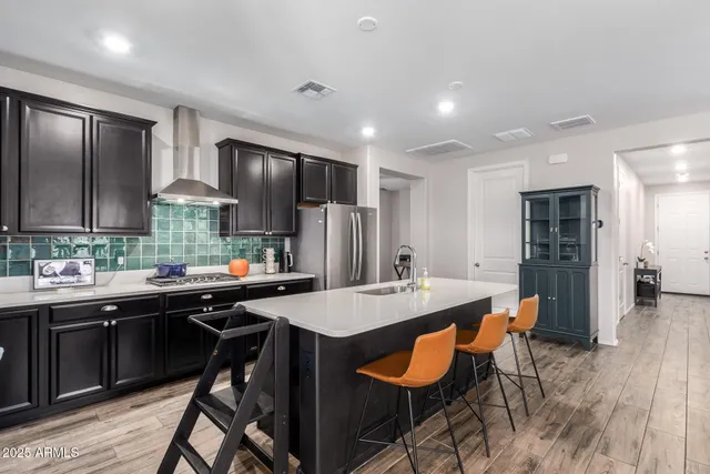 a kitchen with stainless steel appliances kitchen island granite countertop a sink and cabinets