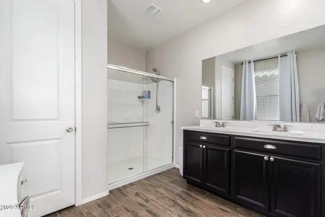a bathroom with double sink and mirror