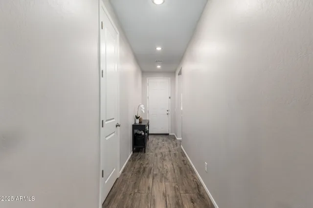 a view of a hallway with wooden floor