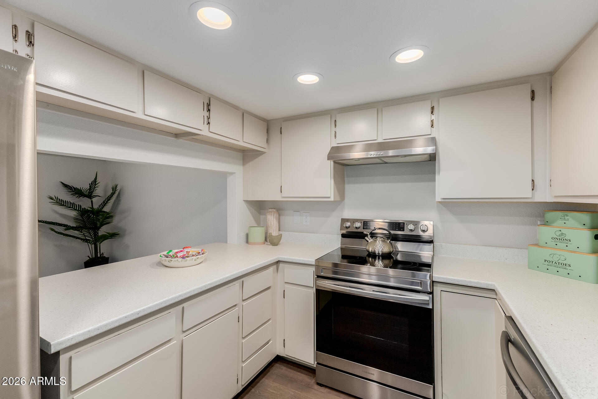 214 East Ruth Avenue, Unit 103 Phoenix, AZ 85020 - Photo 11 of 23 a kitchen with a stove and a cabinets