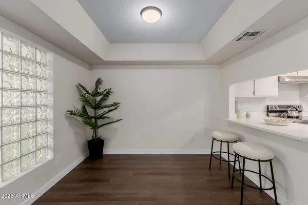 a kitchen with kitchen island a stove a table and chairs in it